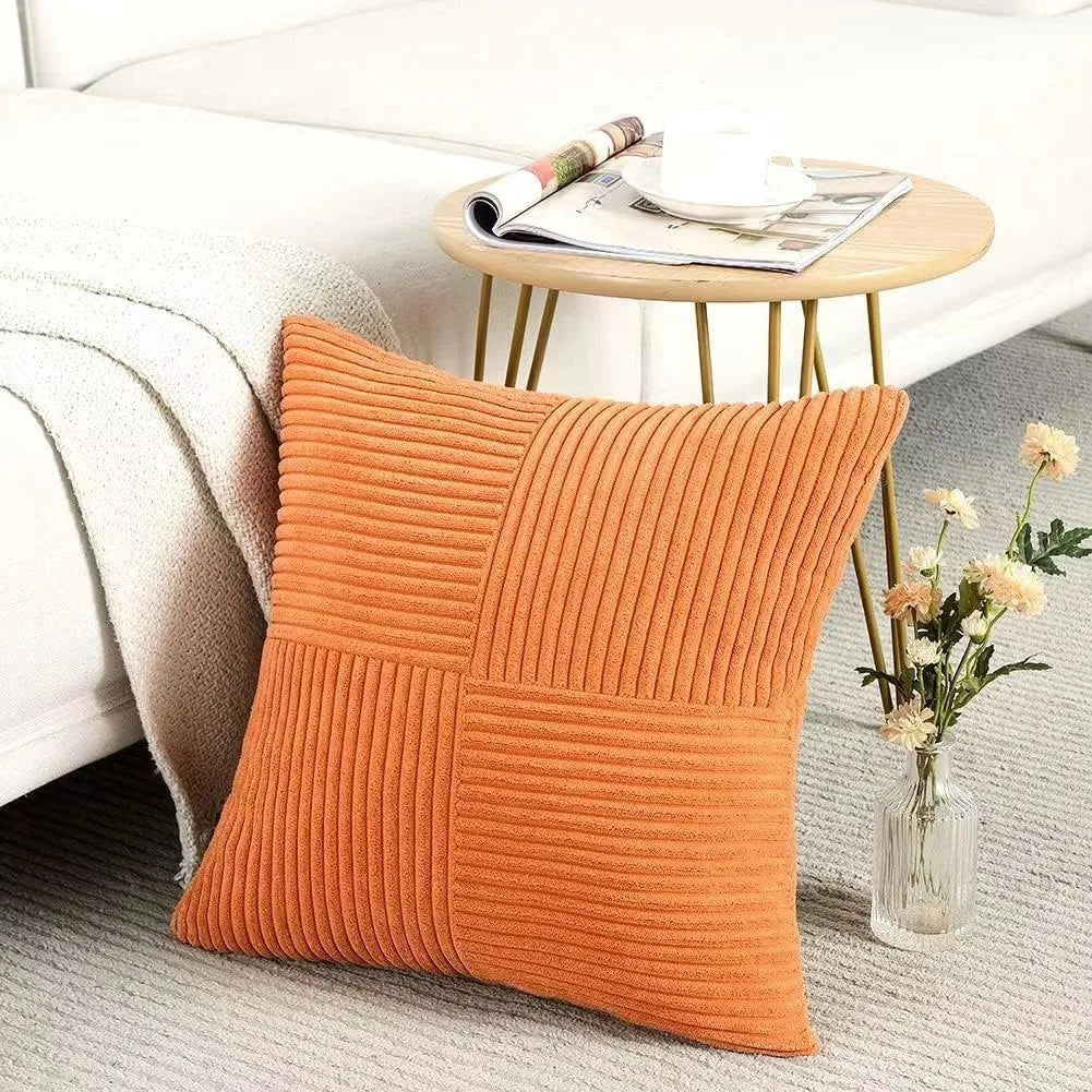 Orange ribbed corduroy cushion cover styled on a chair