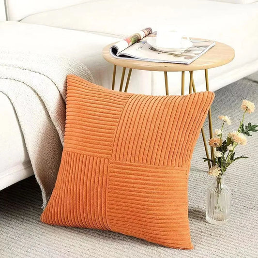Orange ribbed corduroy cushion cover styled on a chair