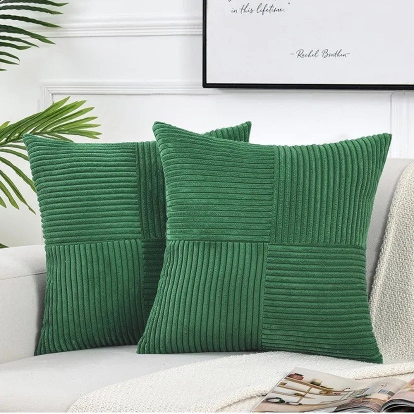 Green ribbed corduroy cushion cover styled on a sofa